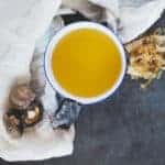 Dashi broth in a bowl with dried shiitake mushrooms, kombu and bonito flakes.