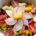 chopped rainbow vegetable salad in white bowl