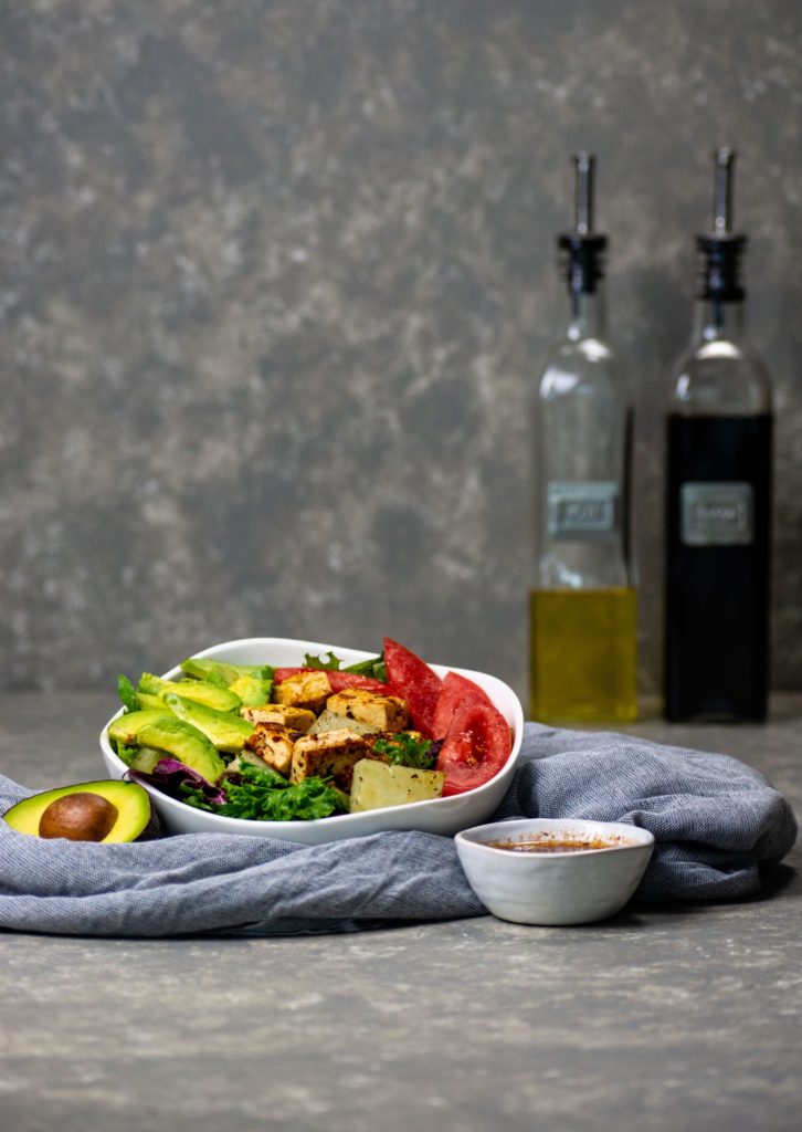 tofu and potato breakfast salad with oil and vinegar bottles