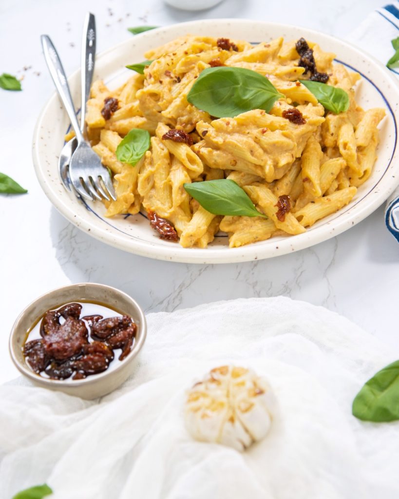 Plate of cauliflower, roasted garlic & sun-dried tomato pasta.