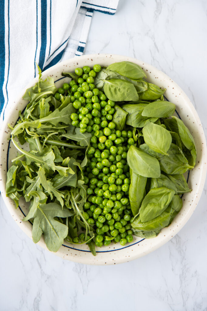 Plate with arugula, green peas and basil