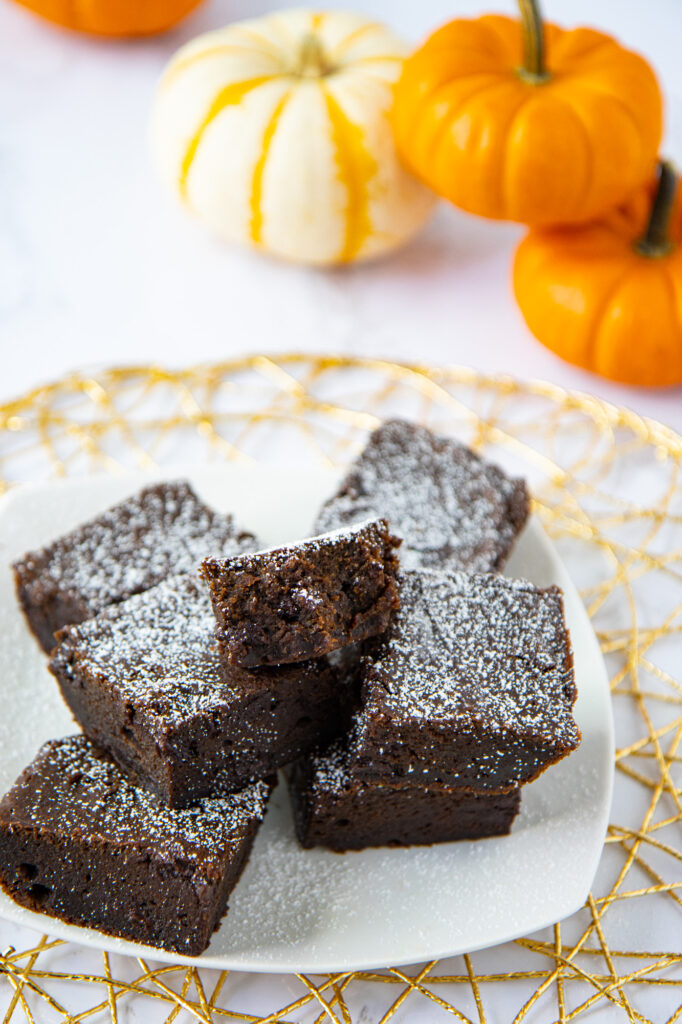 Plate of pumpkin spice brownies with decorative pumpkins