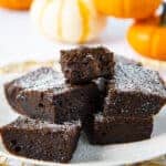 Plate of pumpkin spice brownies with decorative pumpkins