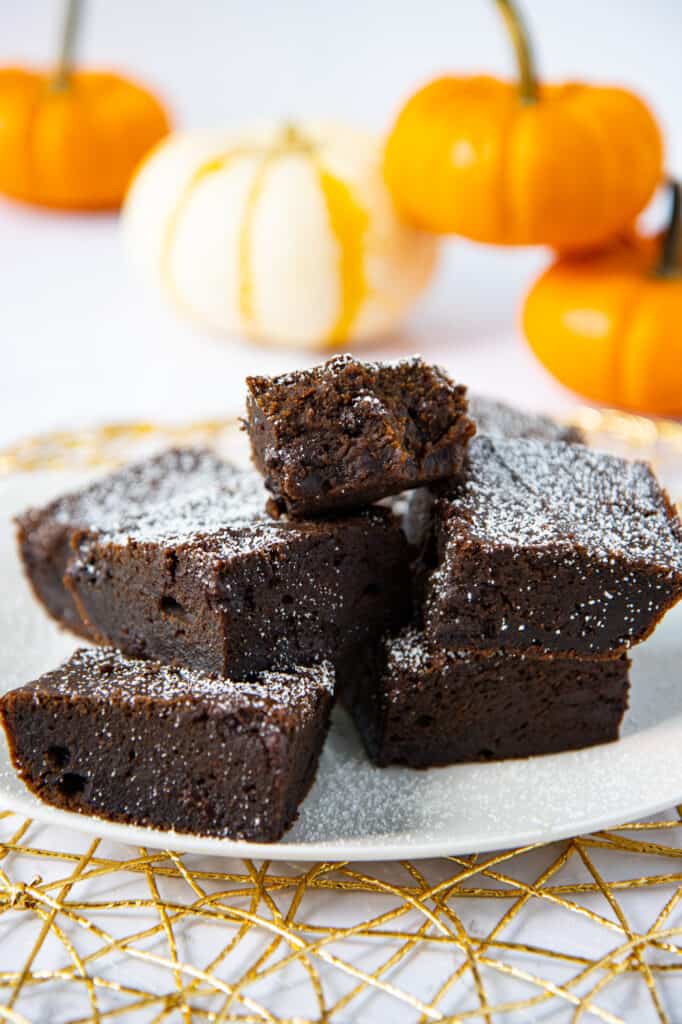 Plate of pumpkin spice brownies with decorative pumpkins