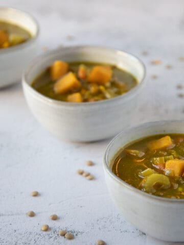 Three bowls of green lentil sweet potato soup