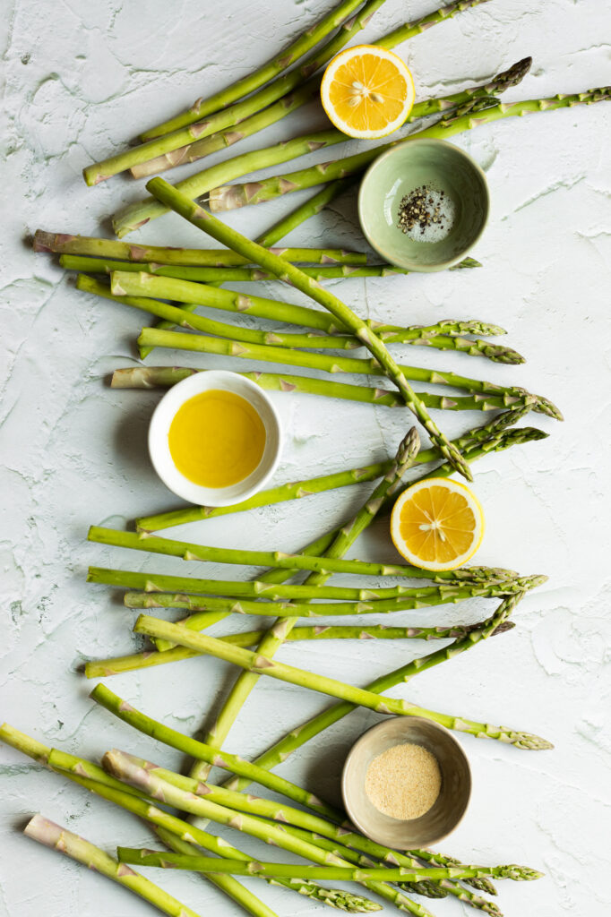 Asparagus with three pinch bowls of spices