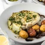 Oven roasted cabbage and potatoes in a white bowl.