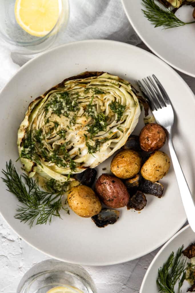 Bowl filled with cabbage and potatoes with lemon dill dressing.