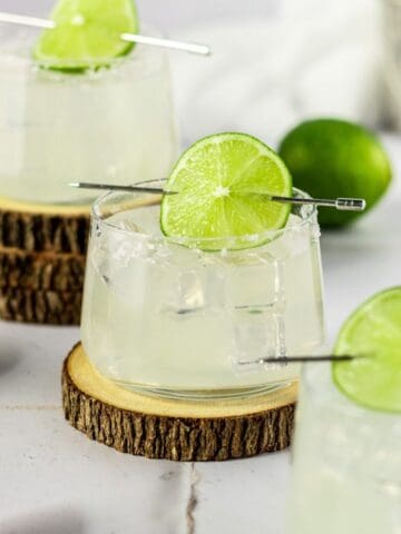 Gin margarita in a glass with a lime wheel.