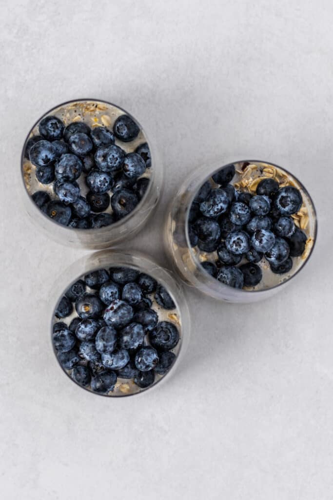 Three glasses with blueberry and oatmeal.