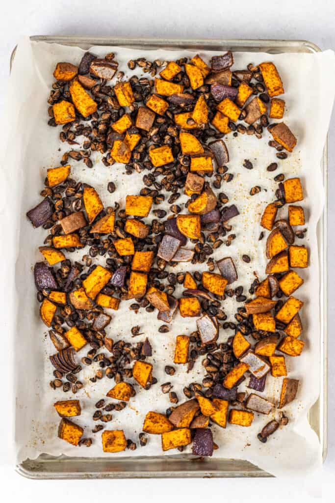 Sheet pan of roasted sweet potatoes, onion and black beans.
