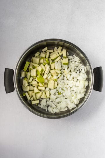 Diced green apple and onion in a large pot.