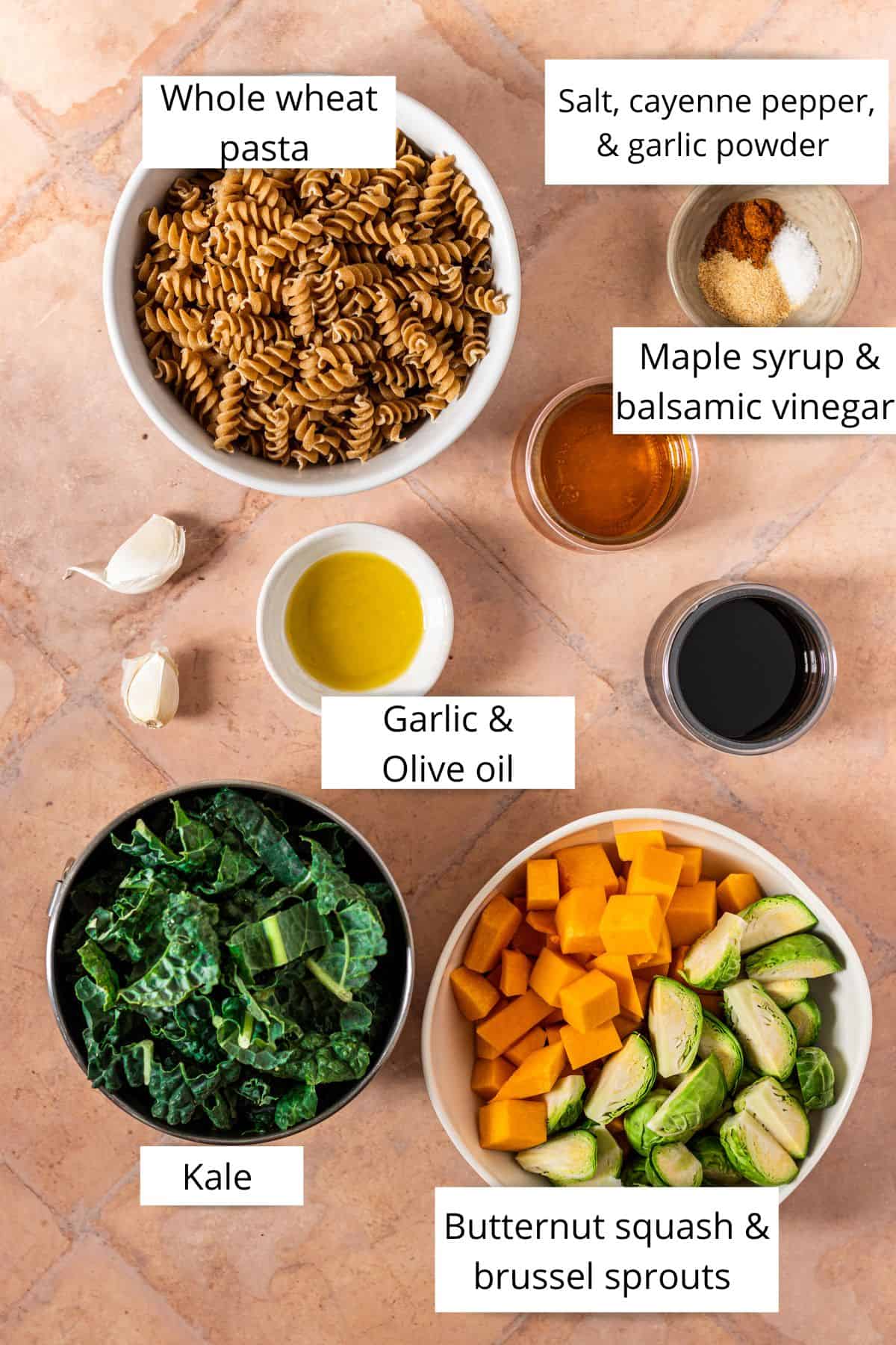 Labeled ingredients in bowls to make fall harvest pasta salad.