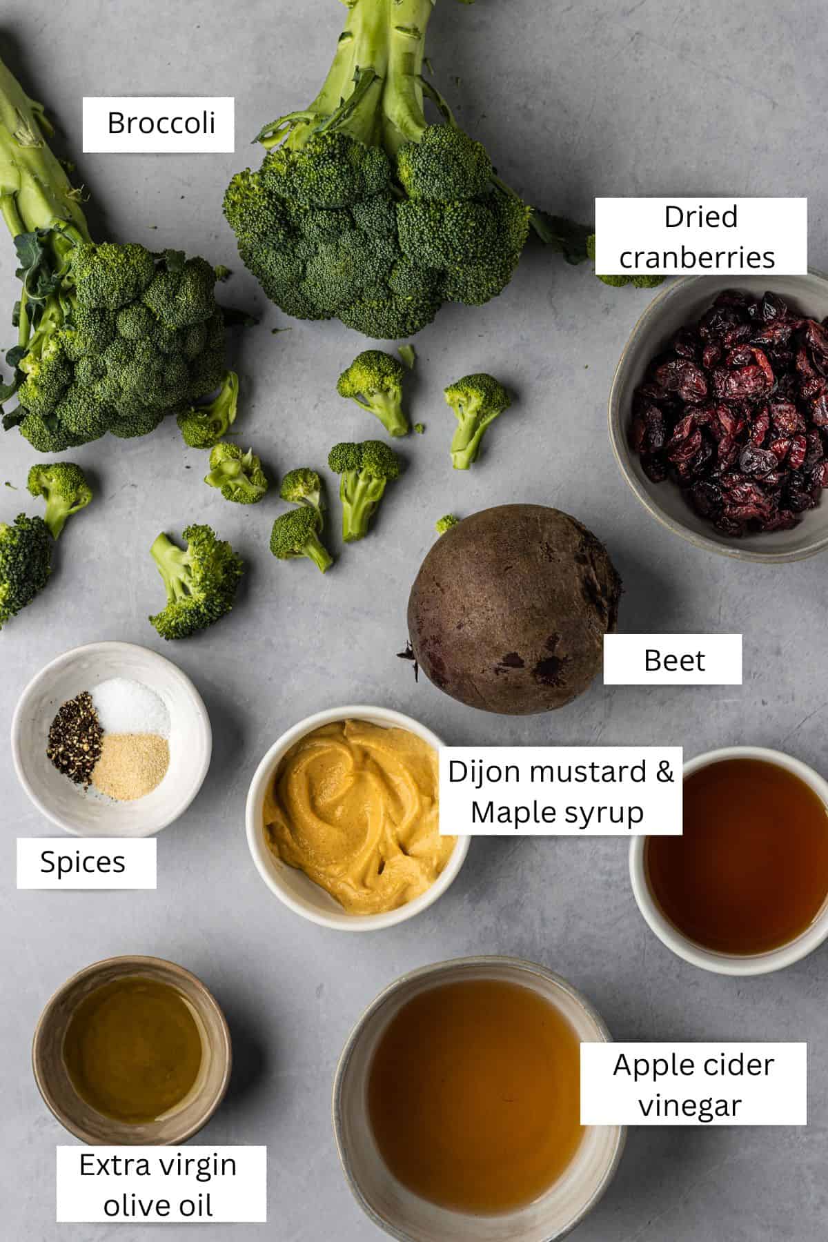 Labeled ingredients in bowls for broccoli beet salad.