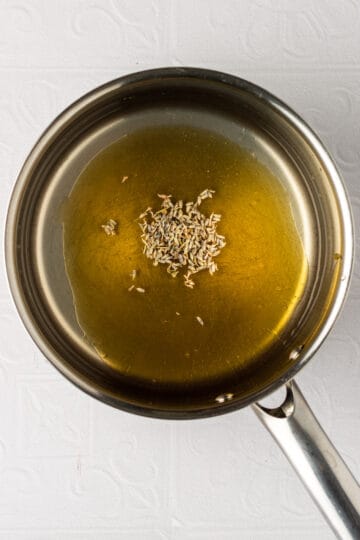 Medium saucepan with dried lavender, honey and water.