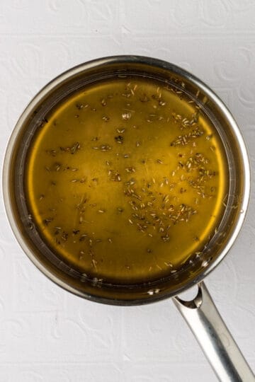 Medium saucepan with dried lavender, honey and water mixed together.