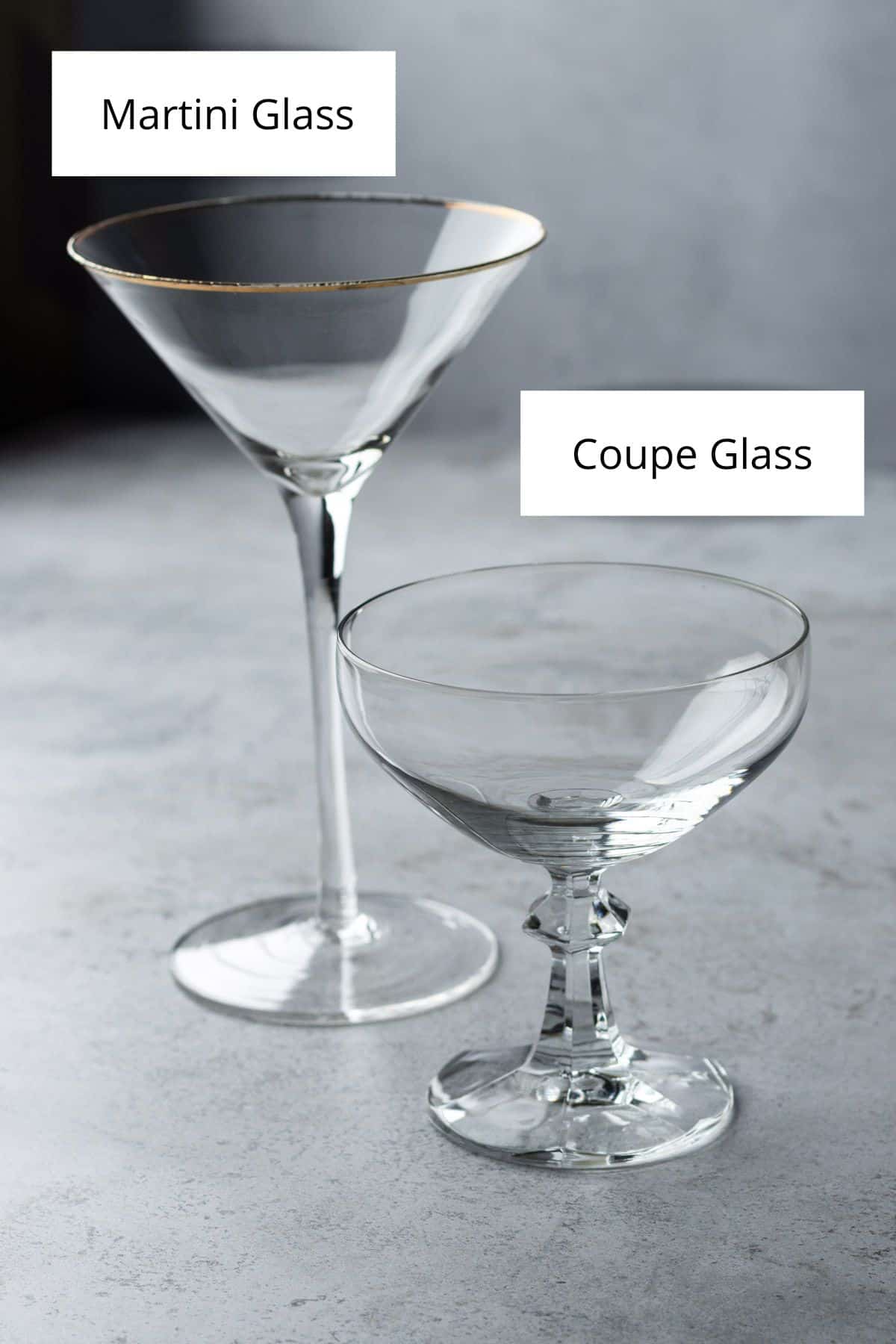 An empty martini glass on the left and an empty coupe glass on the right.