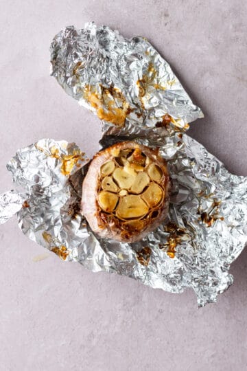 A roasted garlic bulb unwrapped from the foil.