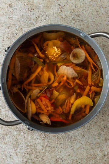 A large pot with vegetables and water.
