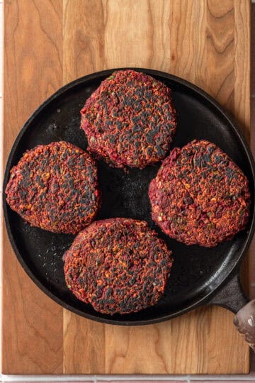 Beet black bean burgers in a cast iron pan.