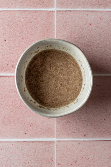 A small bowl of ground flax seed mixed in water.
