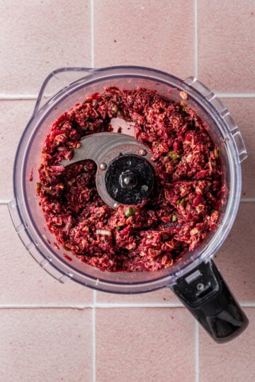 Ingredients for black bean beet burgers in a food processor.