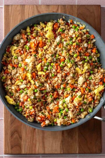 Vegetable fried rice with egg in a pan.