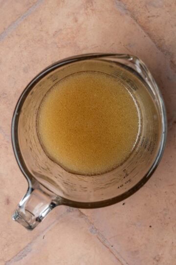 Salad dressing in a liquid measuring cup.
