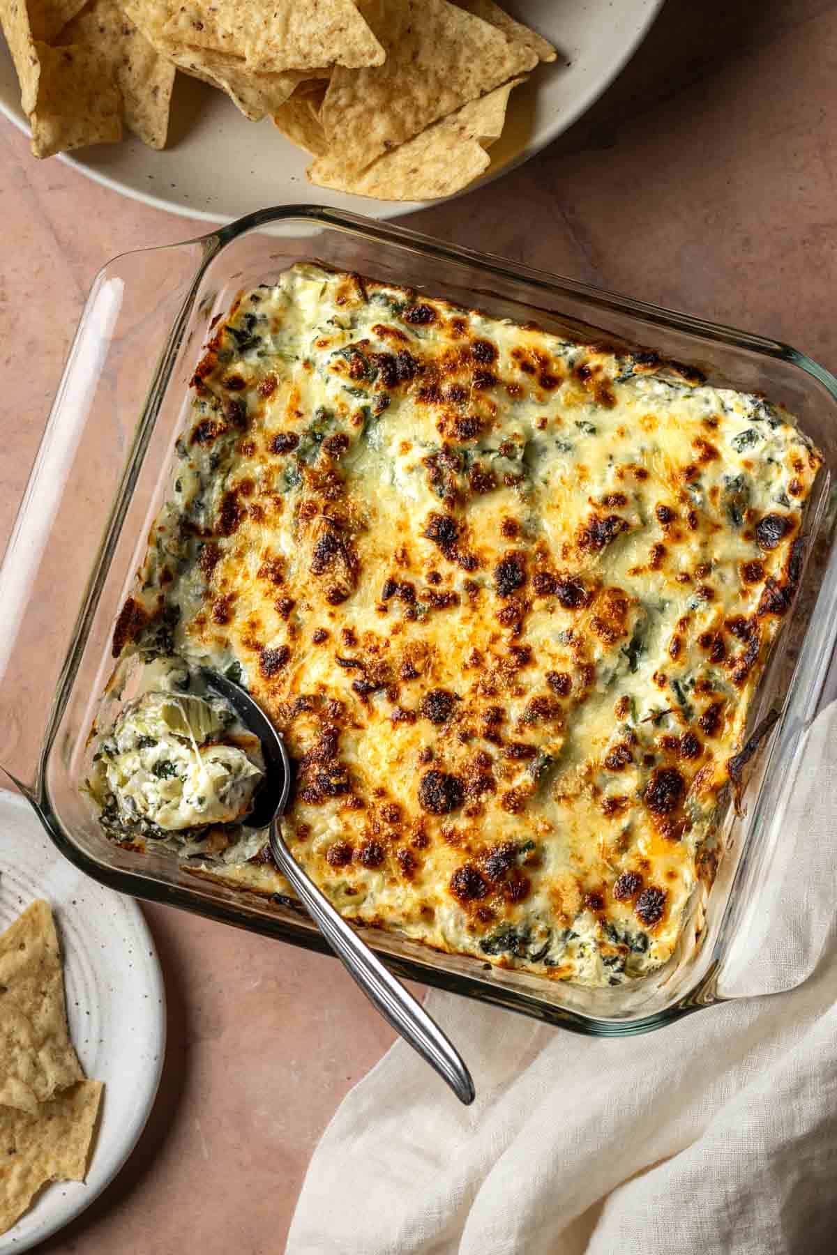 Baked greek yogurt spinach artichoke dip with tortilla chips.