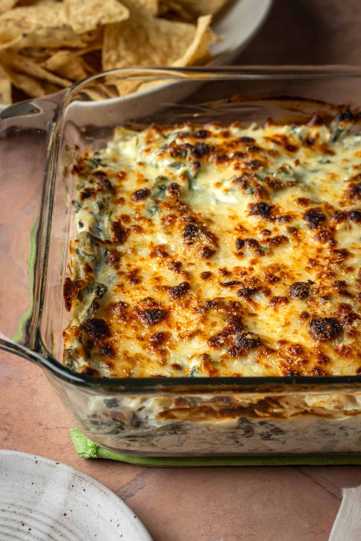 Baked spinach artichoke dip with a lightly browned cheese top.