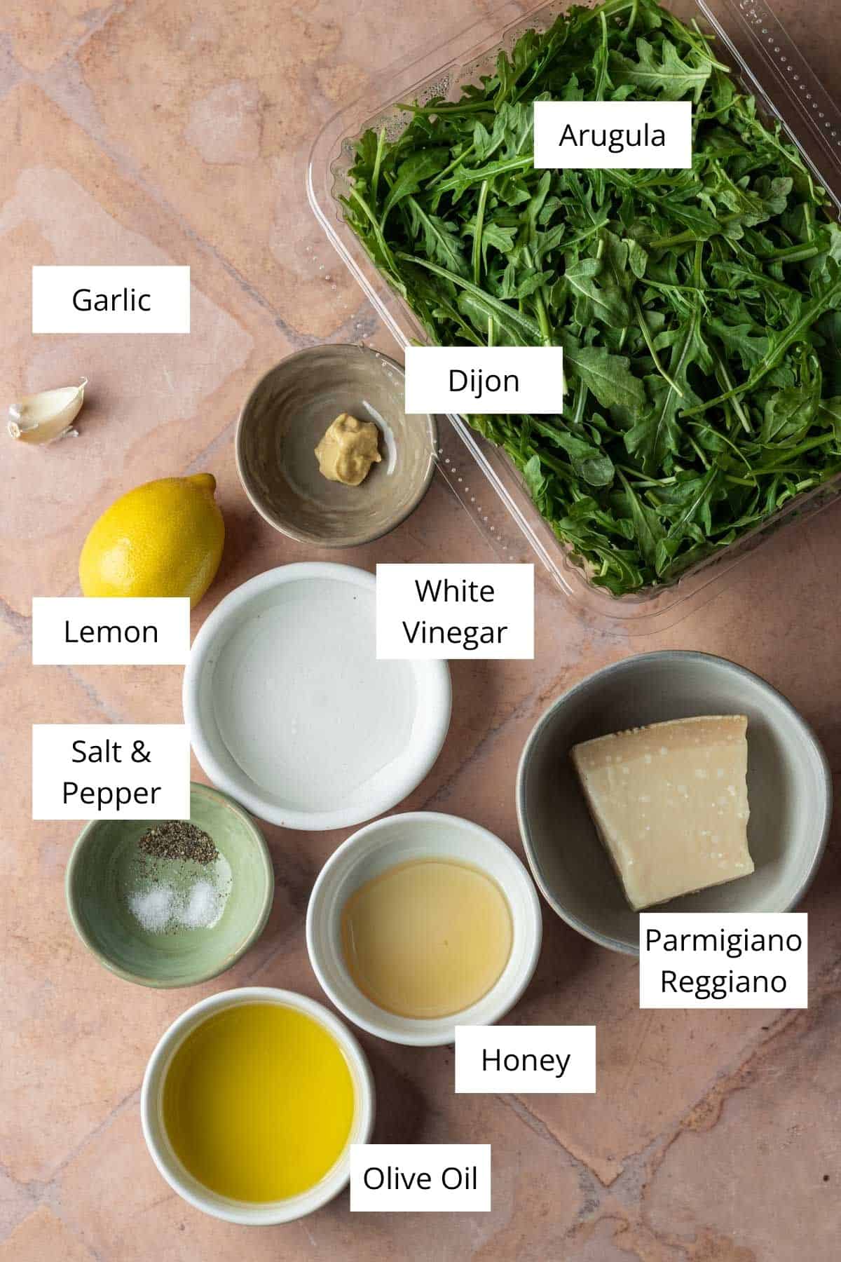 Ingredients for arugula parmesan salad with lemon dressing.