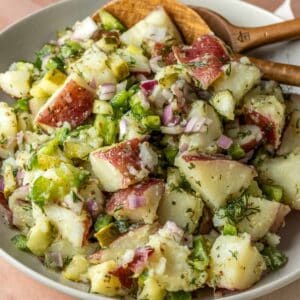 Close up of dill pickle potato salad in a bowl.