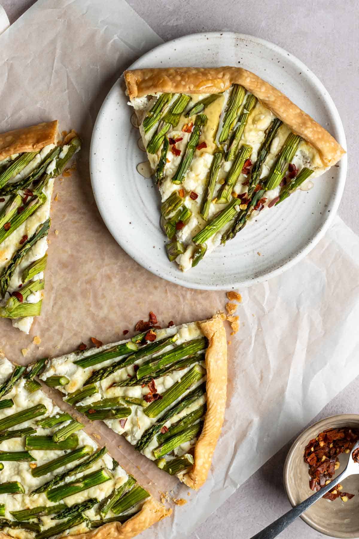 A slice of asparagus galette on a plate.
