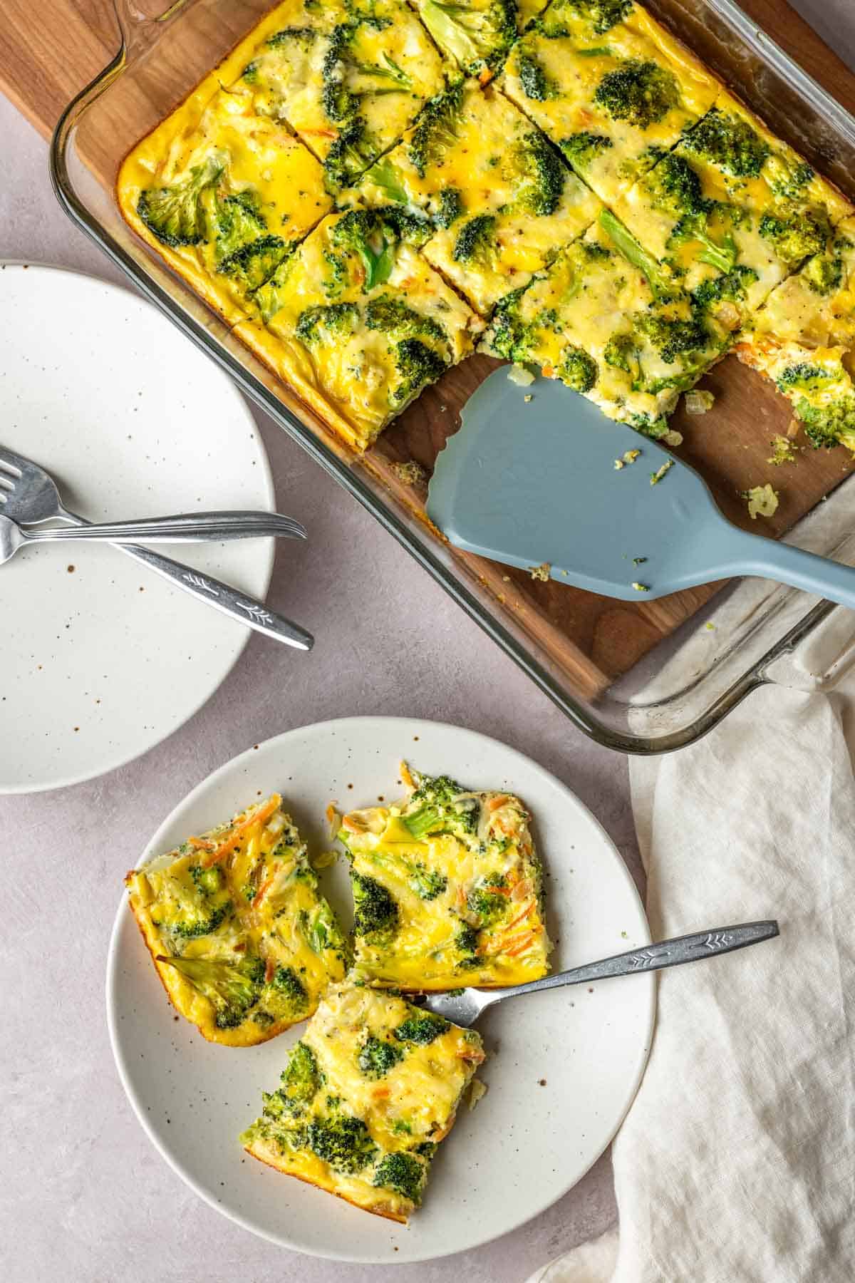 Sliced egg bake casserole being served on a plate.