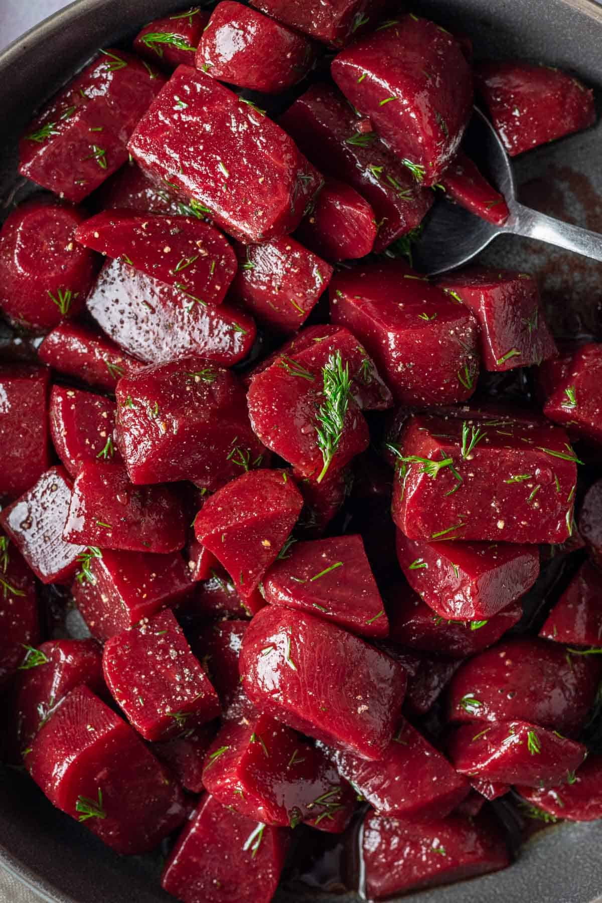Lightly pickled beets with fresh dill in a bowl.
